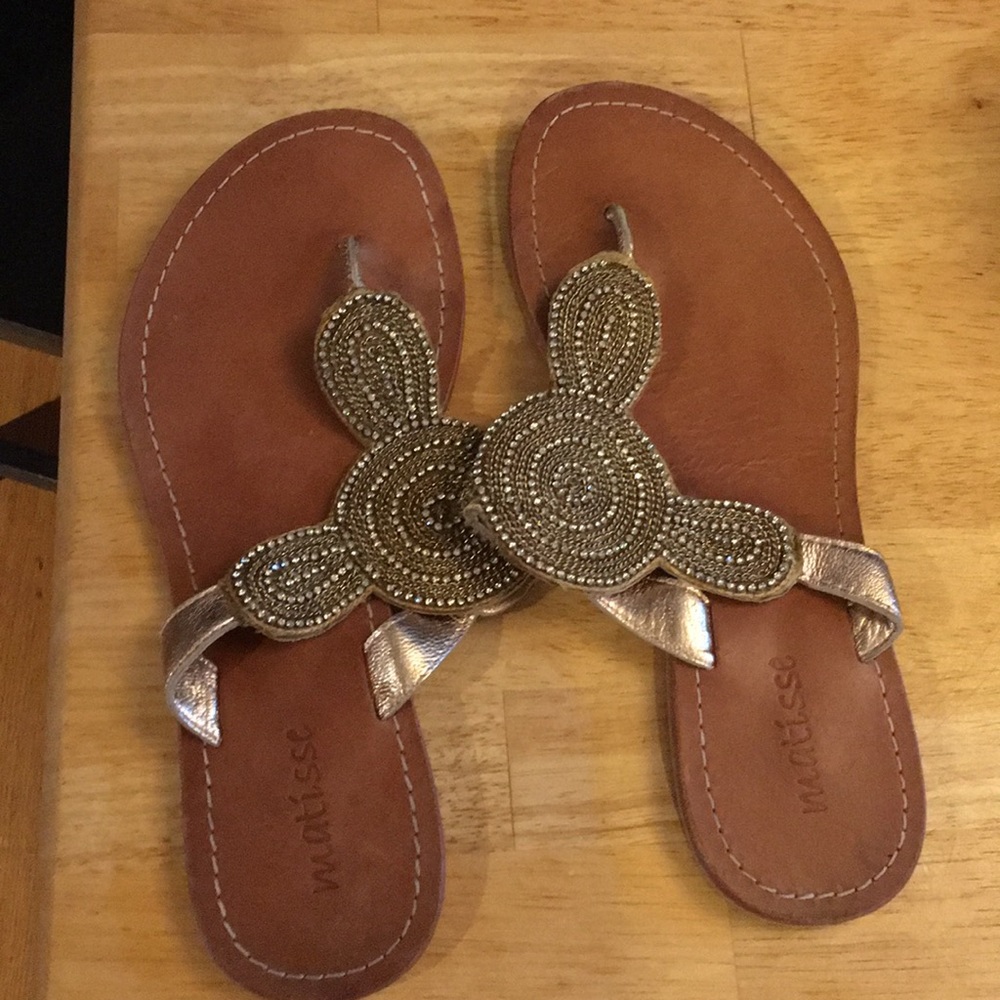 Gold flat sandals.